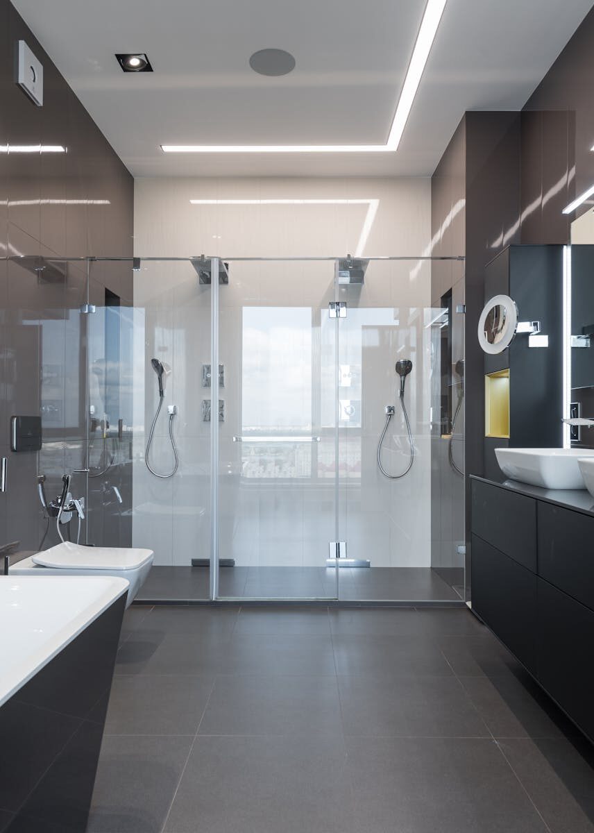 A stylish, contemporary bathroom featuring a sleek glass shower and elegant fixtures.